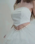 A structured Silk Tulle Tutu Skirt paired with a corseted bodice, hemmed with soft French lace & an Organza Tie up at the back! Do not miss the hand sewn Pearl detailing at the V waist!