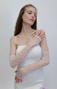 Barbie bride wearing a long fingerless gloves with small white heart on them.